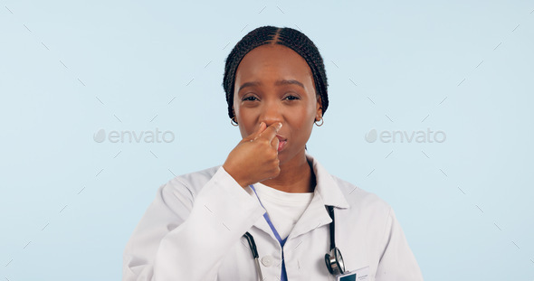 Portrait, black woman and doctor touch nose in studio isolated on blue background mockup space. Fac