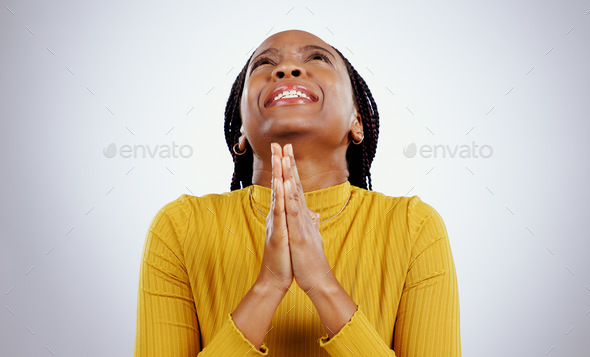 Hands, praying and nervous black woman with wish in studio with sign of anxiety, faith or good luck