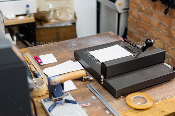 high angle view of blank paper on top of paper trimmer machine in modern print center