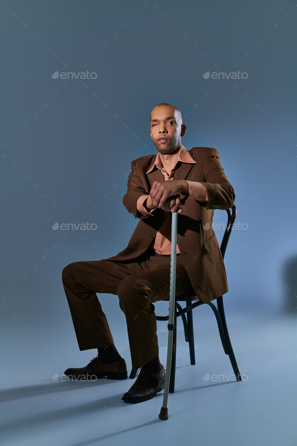 diversity and inclusion, african american man with myasthenia gravis syndrome sitting on chair and