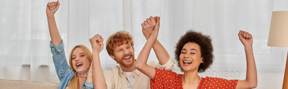 polyamorous relationship, cultural diversity, redhead man raising hands with multiracial female