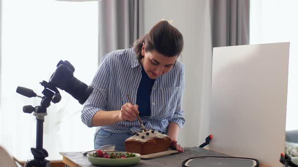 Food Blogger with Camera Working Cake in Kitchen