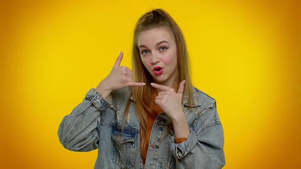 Teenager Girl in Denim Jacket Looking at Camera Doing Phone Gesture Like Says Hey you Call Me Back alt
