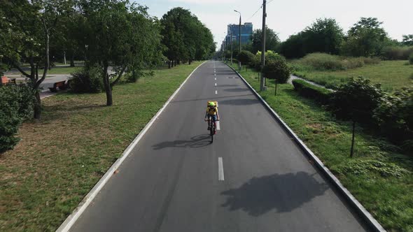 Bicycle Messenger Cycling on a Road alt