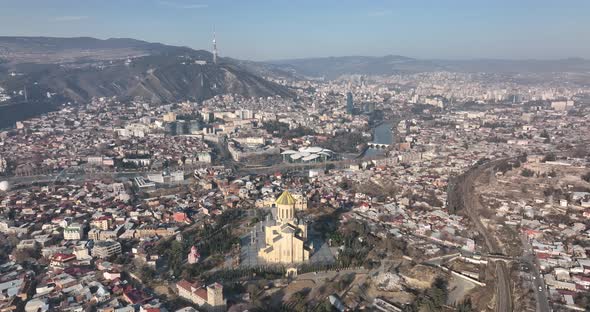 Aerial view of Holy Trinity Cathedral Sameba in Tbilisi Georgia. Sunrise drone footage. alt