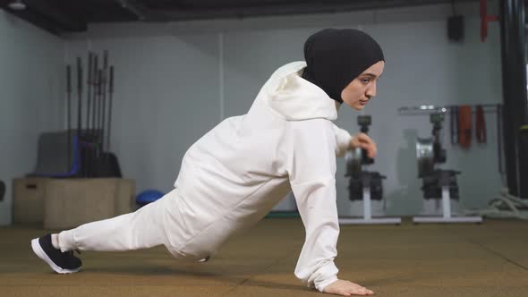 Young Muslim Woman Doing Pushups a Fitness Woman Wearing a Sports Hijab Loves Sports