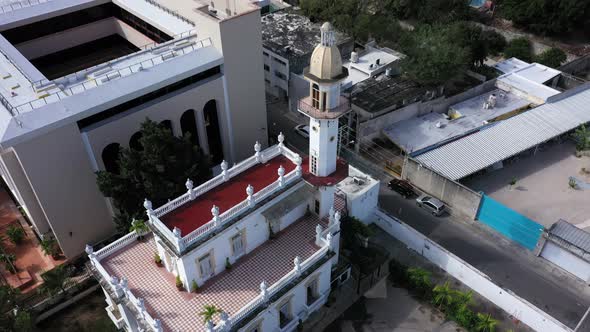 Aerial pull back from the el Minaret mansion revealing the city beyond on the Paseo de Montejo in Me alt