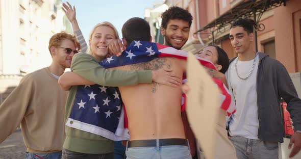 Young Protester with USA Flag Walks to Multiracial Activists and Hugging Them alt