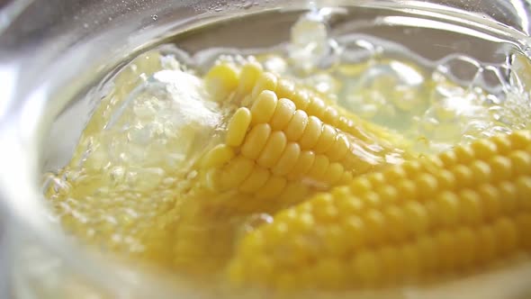 Close Up Sweet Yellow Corn Boiled In Water. Cooking Young Corncobs In Hot Water. The Corn Is Boiled alt