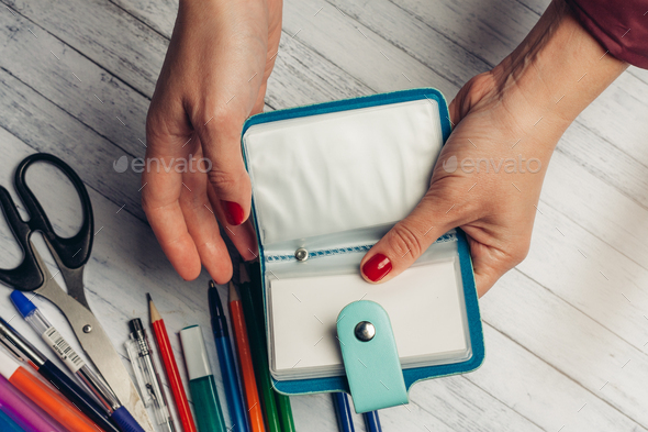 office desk with stationery and scissors pencils business card holder in  hands Stock Photo by shotprime