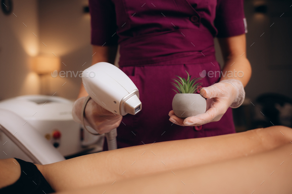 a woman in a laser hair removal Studio poses with a cactus shallow depth of field