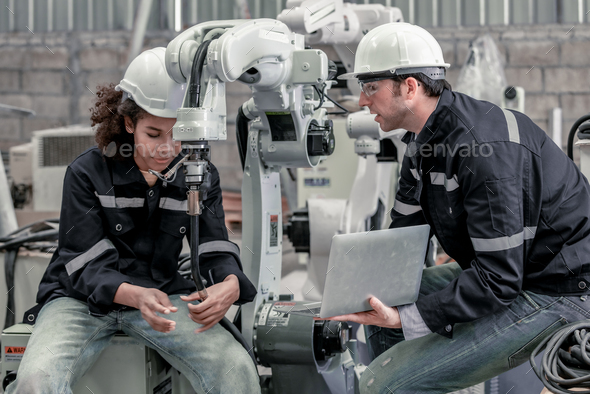Robotics supervisor mentors trainee in automation, machinery setup, and technical skill development.