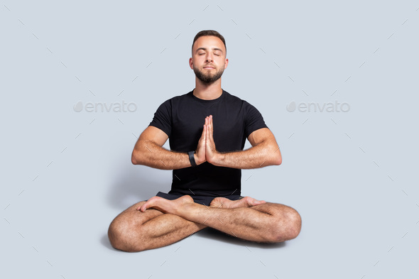 Young man practicing yoga, relax meditation pose Stock Photo by  Prostock-studio