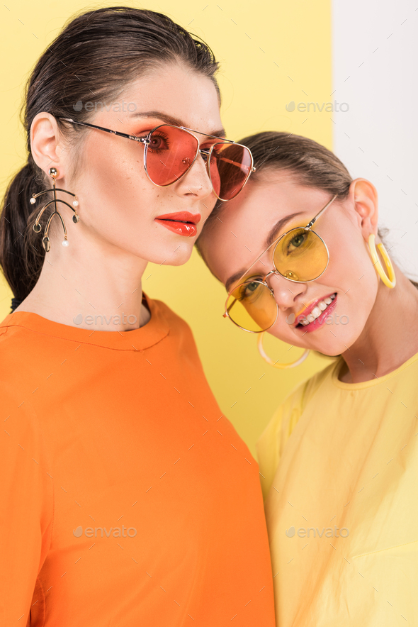 Two beautiful girls friends reading the magazine wearing sunglasses and  denim jeans jackets shorts urban street casual style - Stock Image -  Everypixel