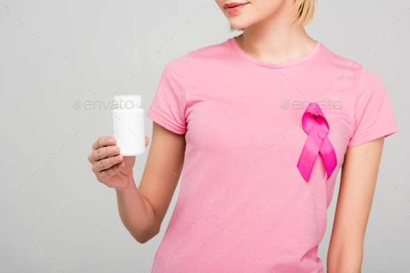 cropped view of girl in pink t-shirt with breast cancer awareness ribbon  holding bottle with Stock Photo by LightFieldStudios