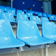 No people on blue plastic chairs of empty tribune at spacious modern stadium - PhotoDune Item for Sale