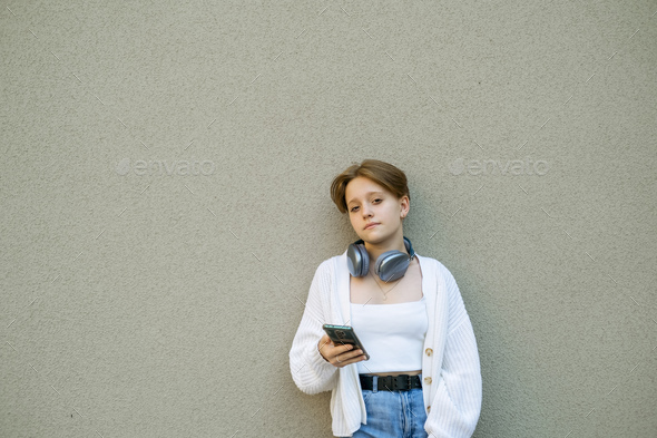 A youth\'s silhouette is etched by the urban beats playing through headphones