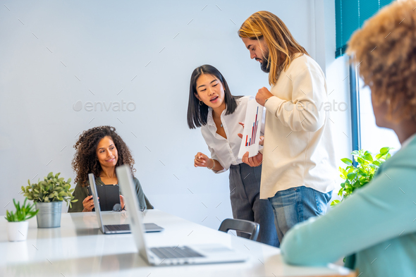 Workers using graphics to provide brief in a meeting