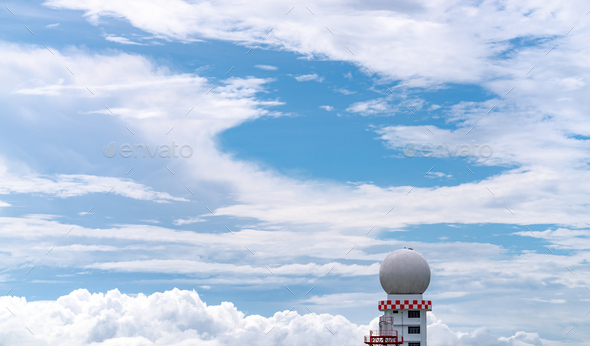 Weather observations radar dome station against blue sky and white fluffy clouds. Aeronautical