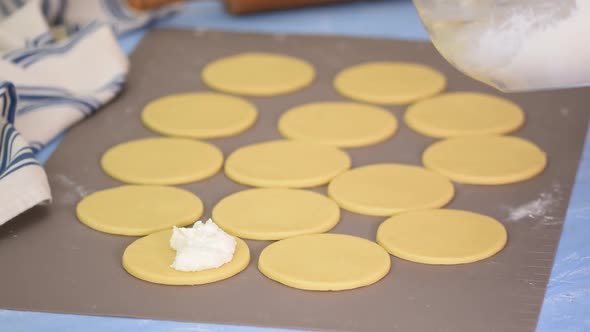 Rolled dough with cottage cheese on table.