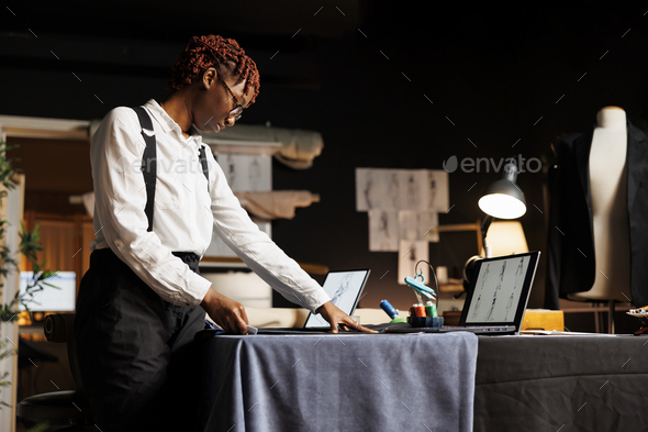 Seamstress using measuring tape Stock Photo by DC_Studio