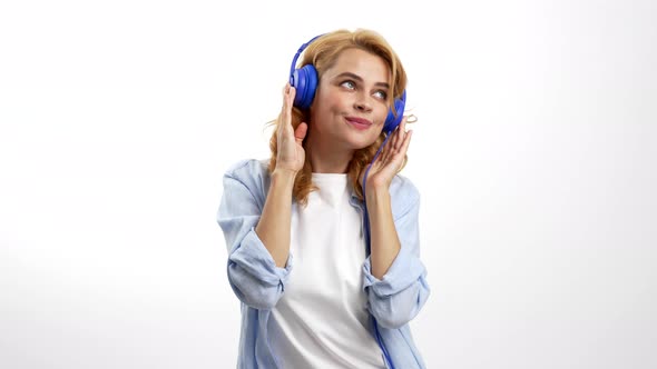 Happy Woman Dancing to Her Favorite Song in Earphones Technology