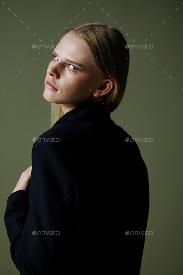 The blonde poses with her back to the camera. Concept photo for clothing  brands. Cool offer for fashionable suits 22253171 Stock Photo at Vecteezy
