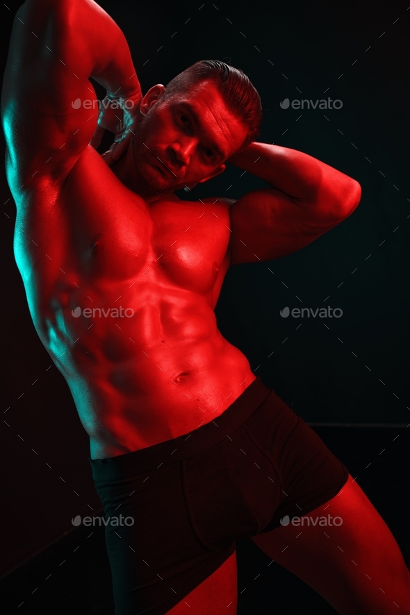  nudist fitness Man bodybuilder posing muscles with nude fitness torso, isolated on black  background in neon light Stock Photo by shotprime