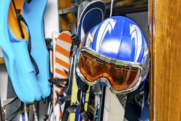 Helmet, ski mask, ski on customized wall mount at warehouse. Extreme ...