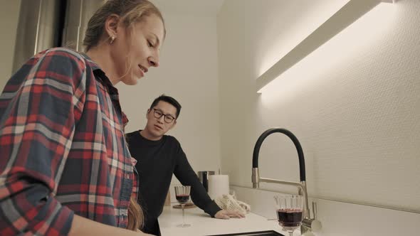 Woman with asian guy prepares dinner alt