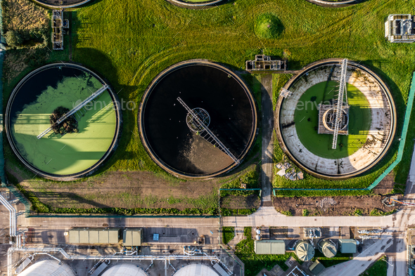 Aerial view above wastewater treatment plant with water storage tank