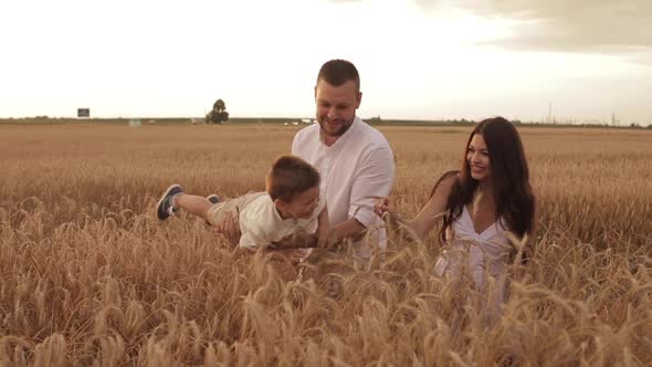 Happy Young Caucasian Parents Amusing Their Man-child