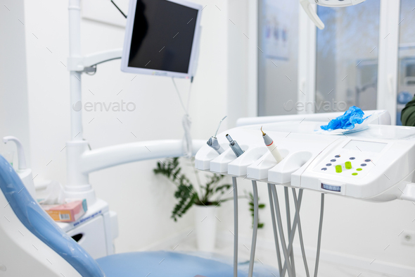 Modern dental practice. Dental chair and other accessories used by dentists in blue, copper light