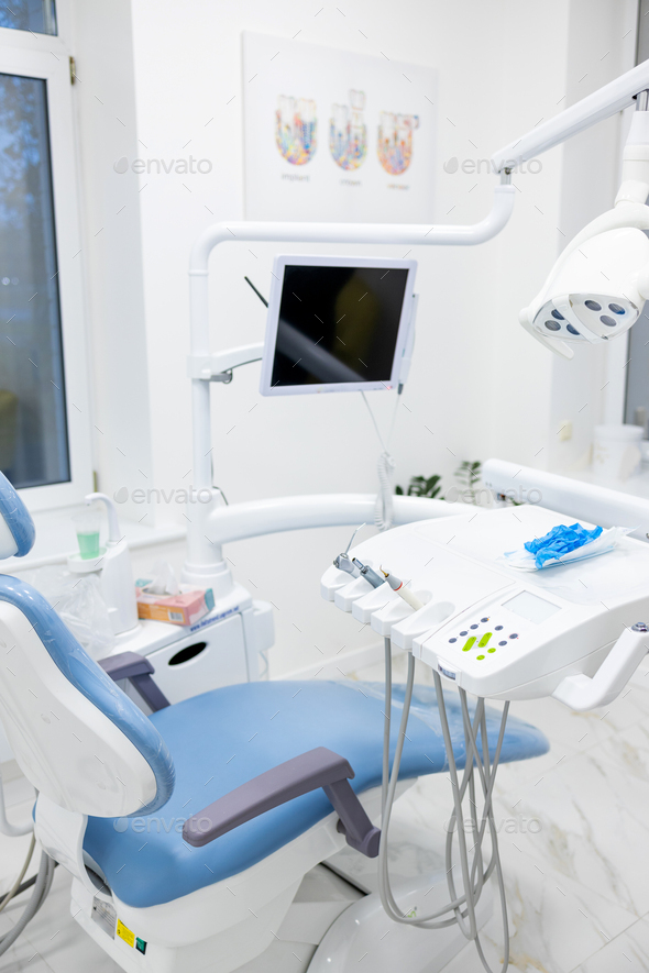 Modern dental practice. Dental chair and other accessories used by dentists in blue, copper light