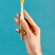 Female hand showing toothbrush in studio - PhotoDune Item for Sale