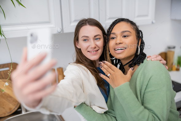 Lesbian Woman Taking Selfie While Cheerful African American Girlfriend Showing Engagement Ring 6432