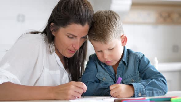 Beautiful Mother Helping Little Son Painting Image Using Colored Felttip Pen alt