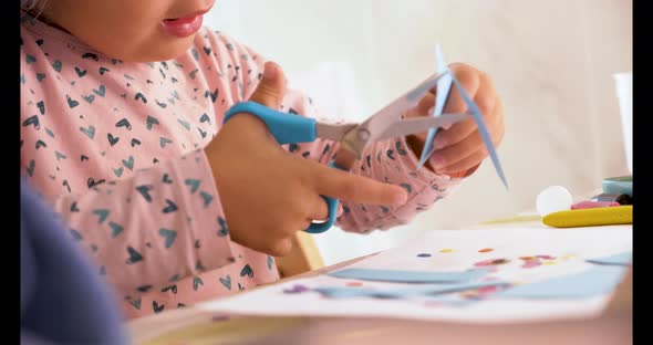 Toddler cutting with scissors and doing crafts