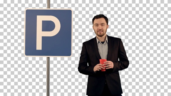 Man with cup of tea near parking sign, Alpha Channel