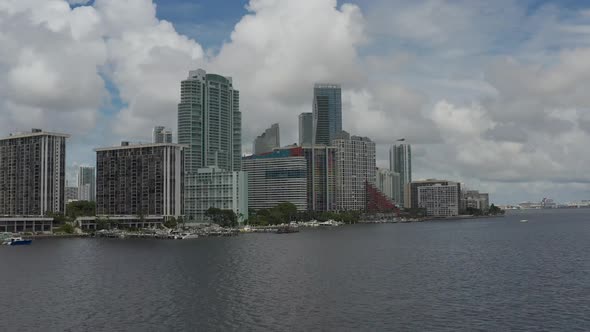 Aerial reveal with minor pan from left to right in downtown Miami setting alt