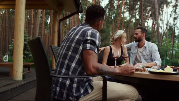 Relaxed Friends Spending Time Together on Backyard alt
