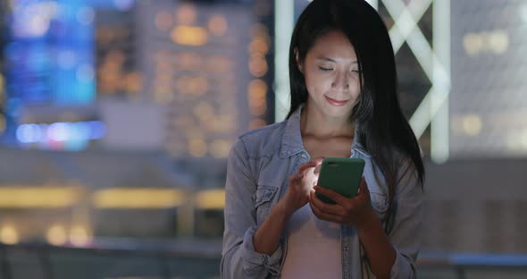 Woman use of cellphone at street alt