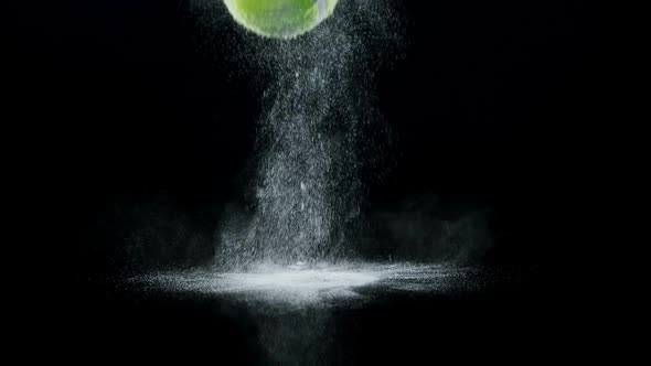 Bouncing ball with powder against black background alt