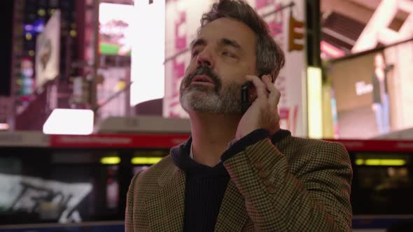 Man talking on cell phone in Times Square, New York City