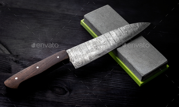 Kitchen Table Displays Large Knife With Sharpening Stone