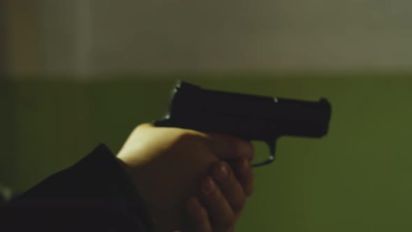 Armed Man in Black Moto Suit Helmet Prowls Holding Gun alt