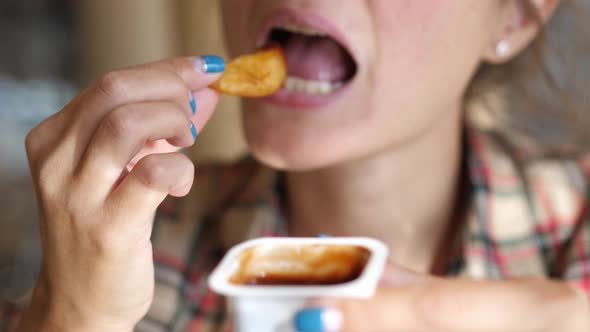 Woman Eating French Fries with Tomato Sauce Harmful and Tasty Fast Food Close Up