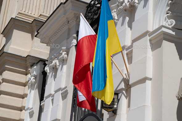 The flags of Ukraine and Poland flutter in the wind. Support and friendship of countries.