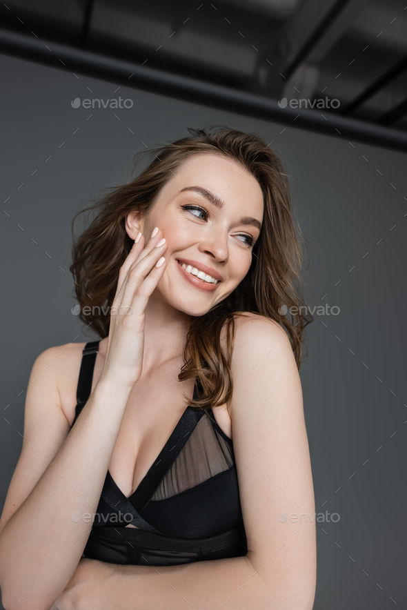 Portrait of fashionable young brunette woman with natural makeup
