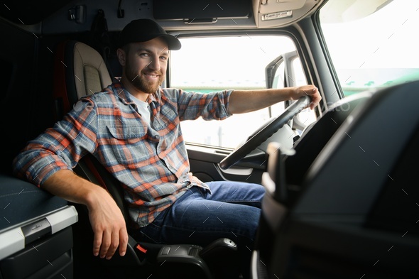 Side View Of Professional Driver Behind The Wheel In Truck's Cabin ...